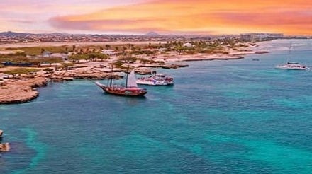 Aerial from Aruba island with Palm Beach in the Caribbean Sea at sunset