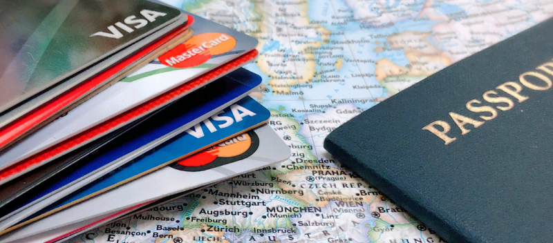 Cartões de crédito empilhados e um passaporte ao lado