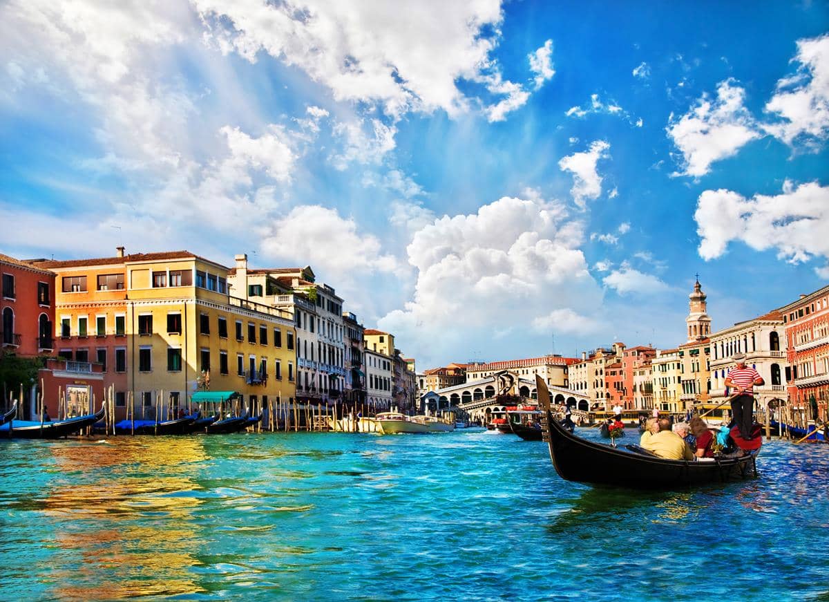 Vista do Grande Canal com algumas gôndolas passeando por ele em Veneza.